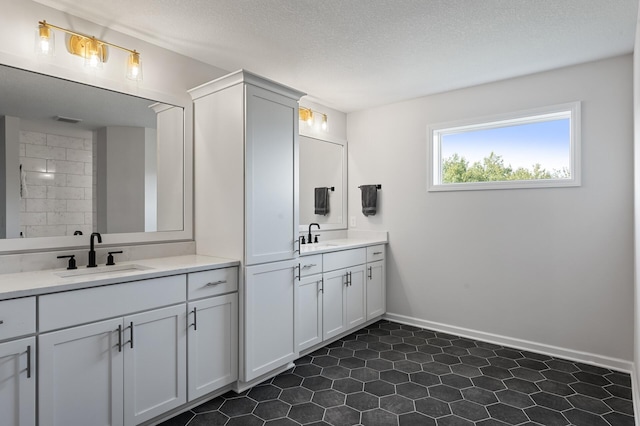 bathroom featuring vanity and a textured ceiling