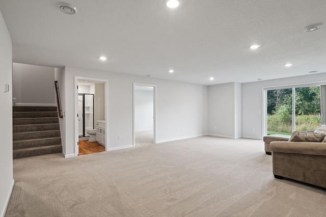 living room with light colored carpet and a textured ceiling