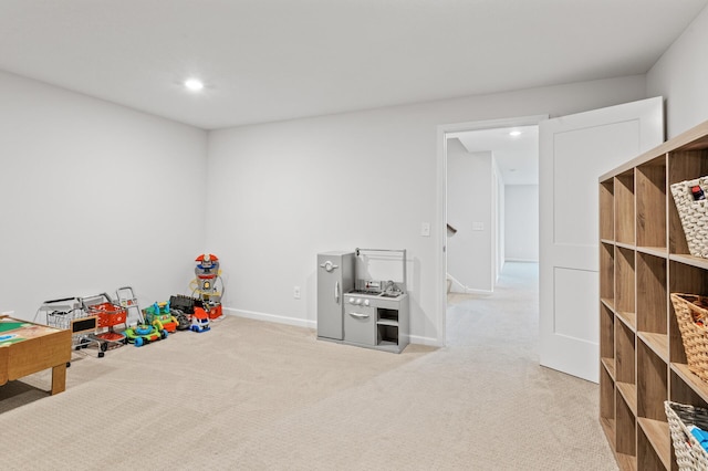 rec room with light colored carpet