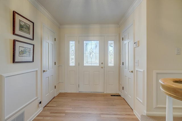 entrance foyer with crown molding and light wood-type flooring