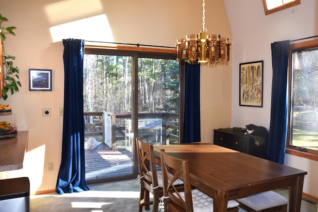 dining space featuring light colored carpet, an inviting chandelier, and lofted ceiling