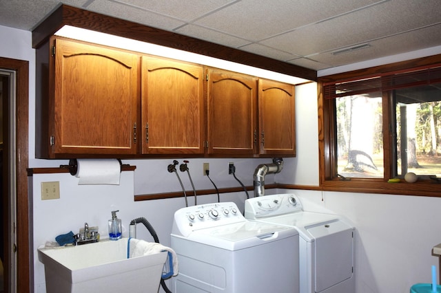 2935 Acorn Ln NE, Bemidji, MN 56601 - washroom featuring cabinet space and washing machine and clothes dryer