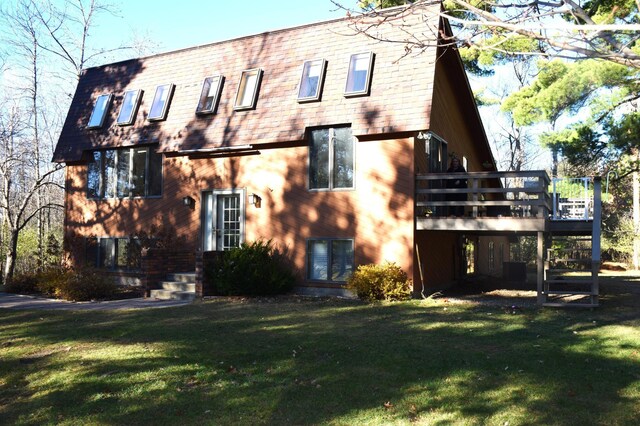 2935 Acorn Ln NE, Bemidji, MN 56601 - back of house with a lawn and a wooden deck