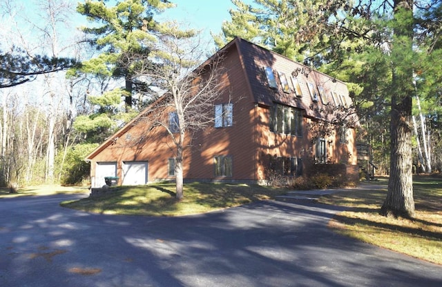 view of home's exterior with an outbuilding and a garage