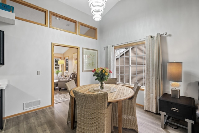 dining area with hardwood / wood-style flooring and lofted ceiling