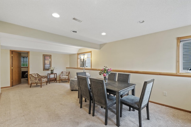 dining area featuring light carpet