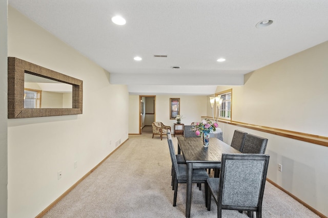 dining room featuring light carpet