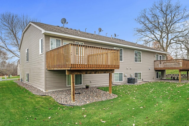 rear view of house featuring a lawn, a wooden deck, and central air condition unit