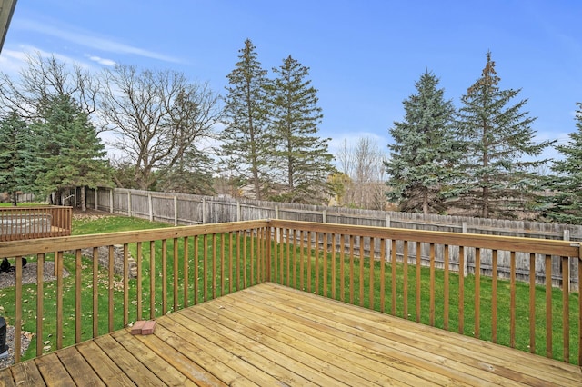 wooden terrace featuring a lawn