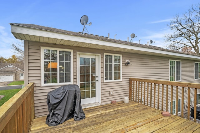 wooden terrace featuring a grill