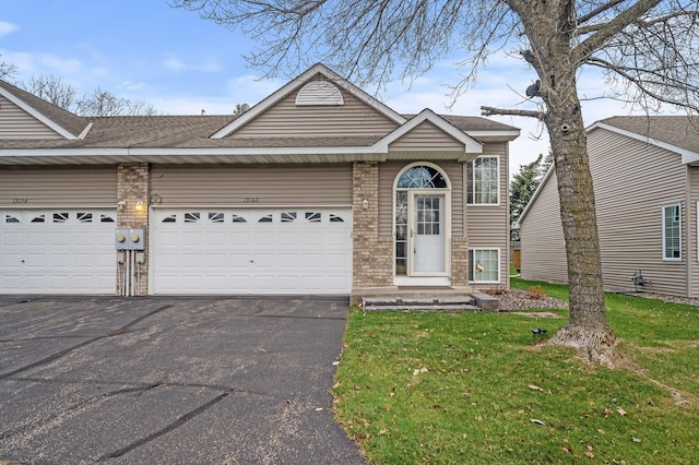 view of front facade with a front lawn and a garage