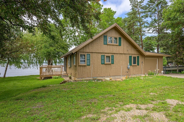 22077 Csah 14, Darwin, MN 55324 - view of property exterior with a garage, a lawn, a deck with water view, and concrete driveway