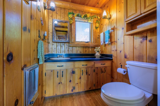 22077 Csah 14, Darwin, MN 55324 - half bathroom featuring wood finished floors, vanity, and wood walls