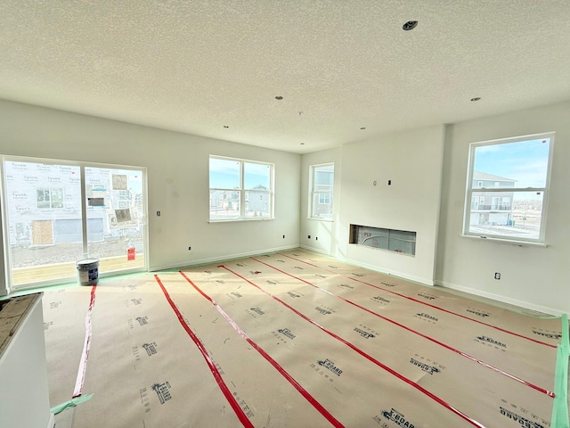 unfurnished living room featuring a textured ceiling