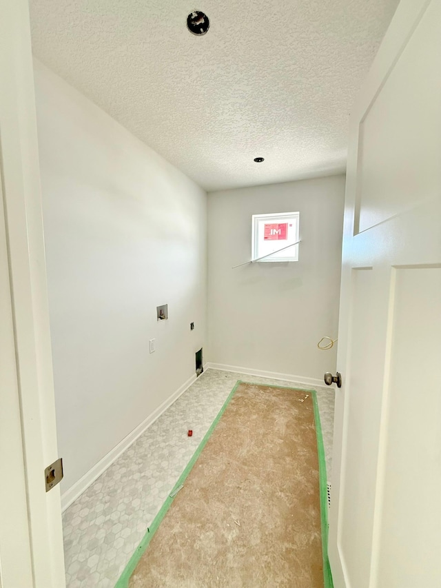 laundry area with a textured ceiling