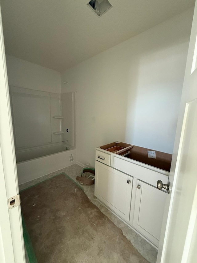 bathroom featuring concrete flooring, vanity, and shower / bathtub combination