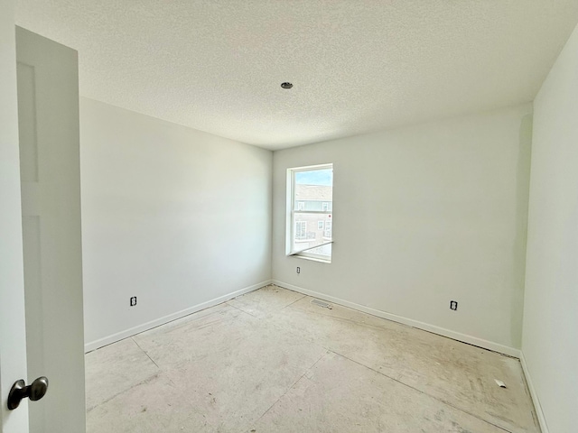 spare room with a textured ceiling