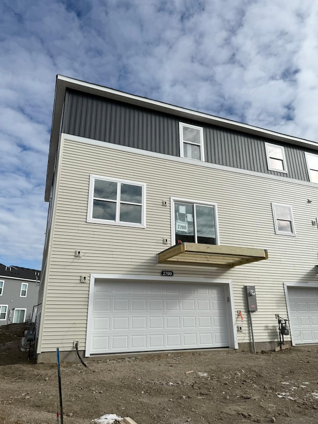 back of property with a garage