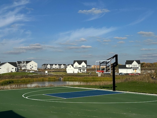 view of basketball court featuring a water view