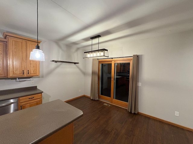 kitchen with dark wood-type flooring, decorative light fixtures, and dishwasher