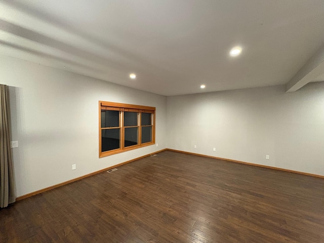 empty room featuring dark wood-type flooring