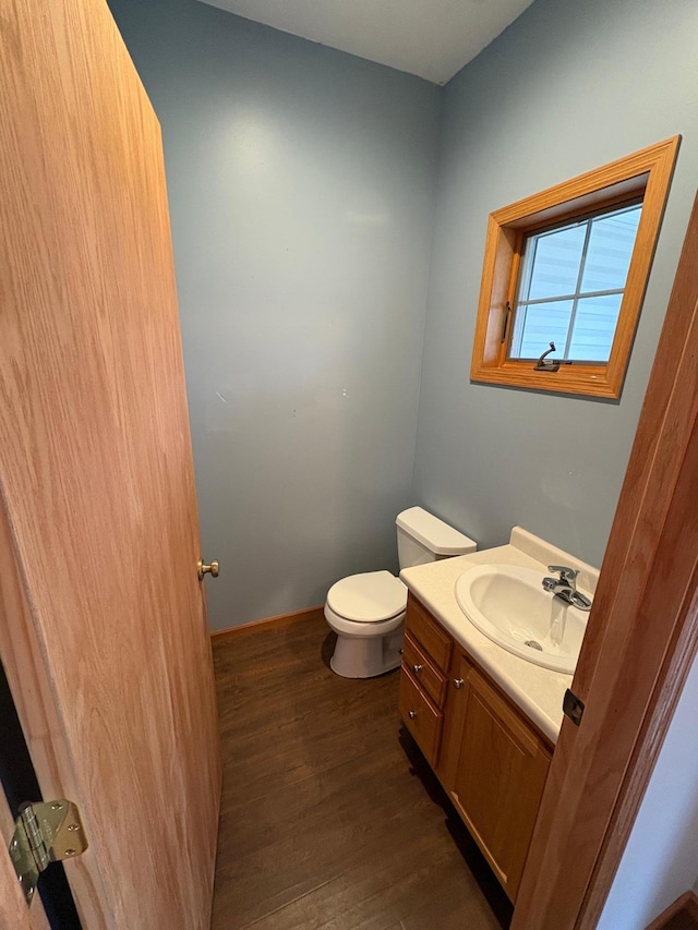 bathroom featuring hardwood / wood-style flooring, vanity, and toilet