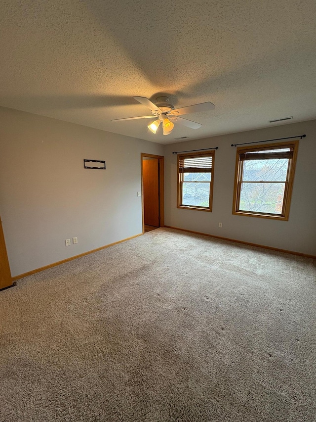 unfurnished room featuring ceiling fan, a textured ceiling, and carpet flooring