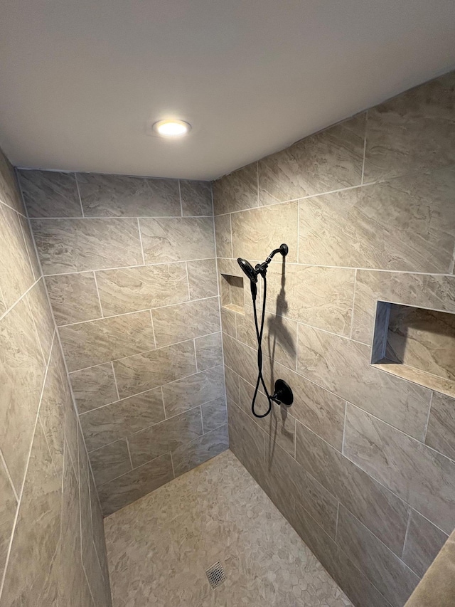 bathroom with a tile shower