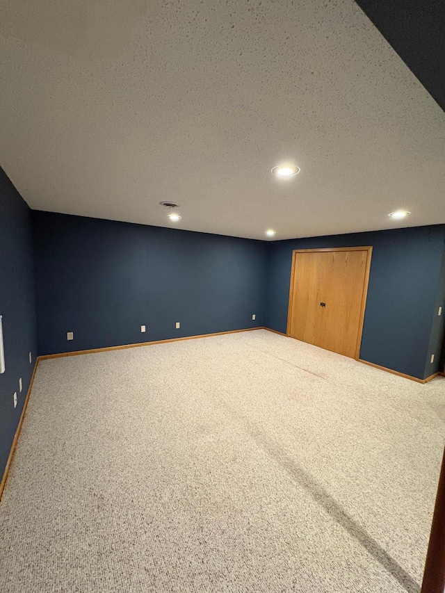 basement with a textured ceiling and carpet floors