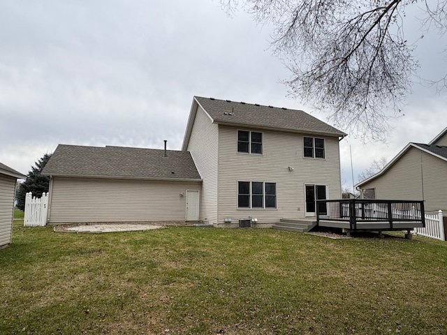 rear view of house with a wooden deck, cooling unit, and a yard