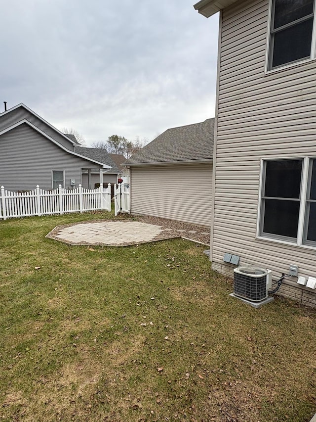 view of yard with central air condition unit and a patio area