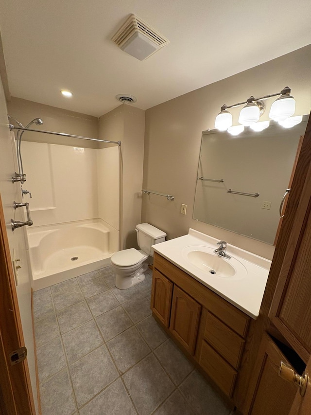 bathroom featuring toilet, vanity, tile patterned floors, and walk in shower