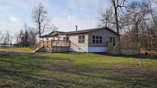 back of house with a deck and a lawn