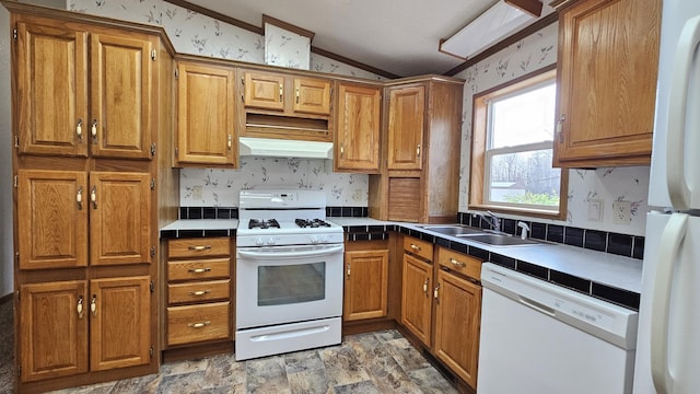 kitchen with tile counters, white appliances, sink, and lofted ceiling