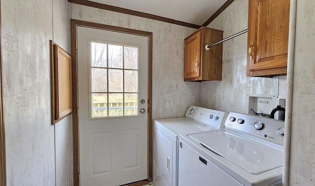 clothes washing area with washer and clothes dryer, cabinets, and ornamental molding