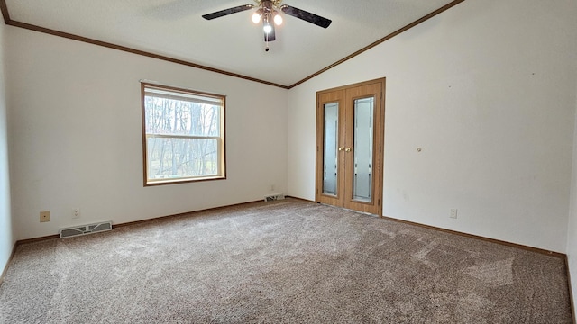 carpeted spare room with a textured ceiling, ceiling fan, lofted ceiling, and ornamental molding