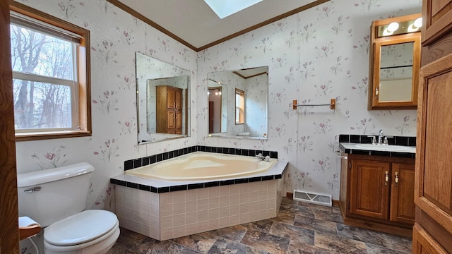 bathroom featuring a relaxing tiled tub, crown molding, vaulted ceiling, toilet, and vanity