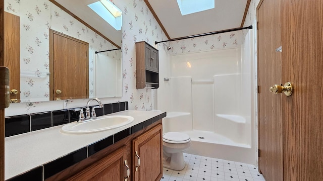 bathroom featuring lofted ceiling with skylight, crown molding, a shower, toilet, and vanity