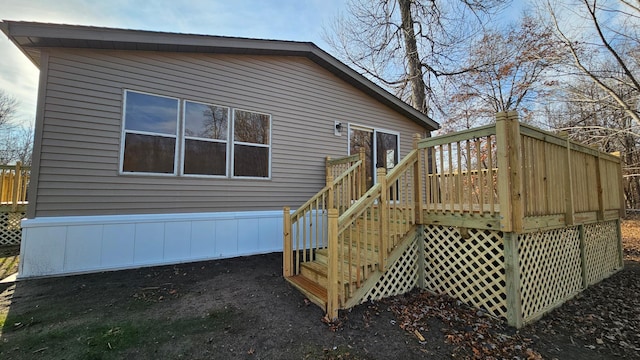 rear view of house featuring a wooden deck