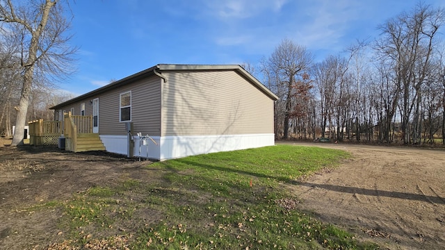 view of home's exterior featuring central AC unit and a deck