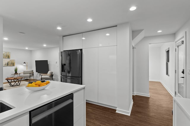 kitchen with dark hardwood / wood-style flooring, stainless steel fridge with ice dispenser, dishwasher, and white cabinets