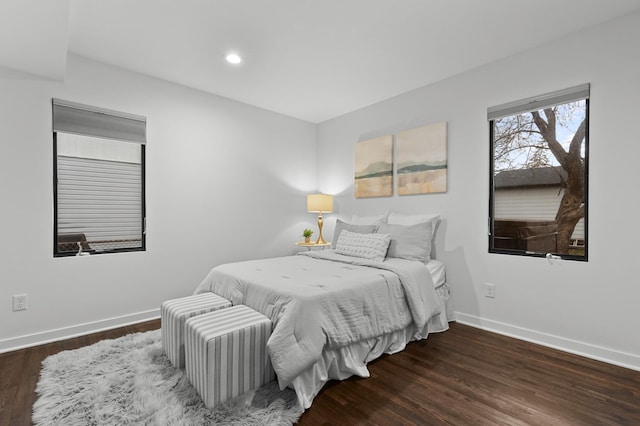 bedroom with dark hardwood / wood-style floors