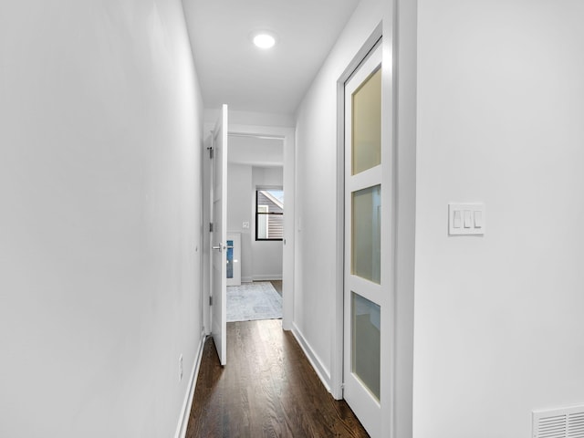 hallway with dark wood-type flooring