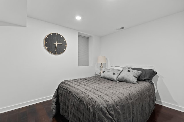 bedroom with dark hardwood / wood-style floors