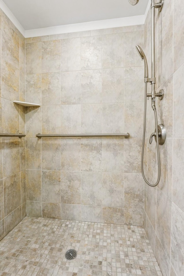 full bath with a tile shower