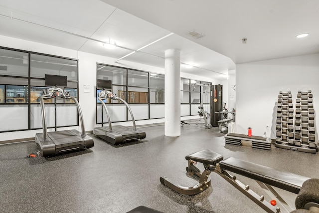 exercise room featuring visible vents and ornate columns