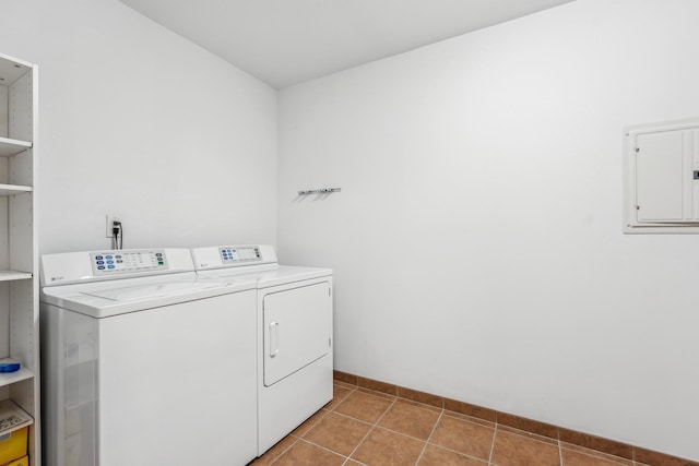 laundry room featuring laundry area, electric panel, washer and dryer, and tile patterned floors