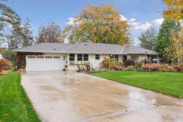 single story home featuring a front yard and a garage