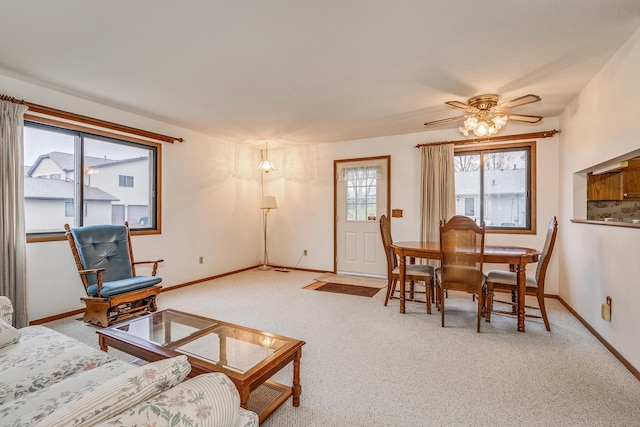 living room with ceiling fan and light colored carpet