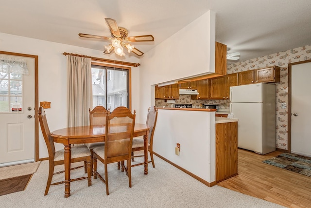 dining space featuring light wood-type flooring and ceiling fan